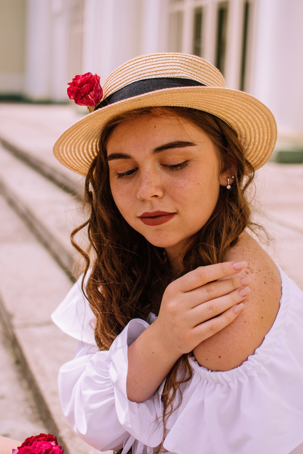 woman in white long sleeve shirt wearing brown hat