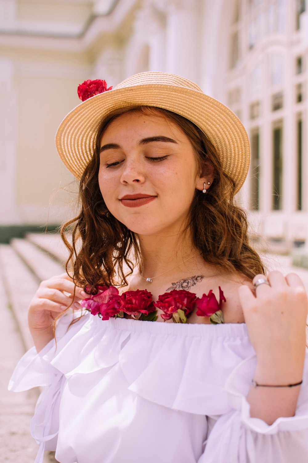 woman in white dress wearing brown straw hat