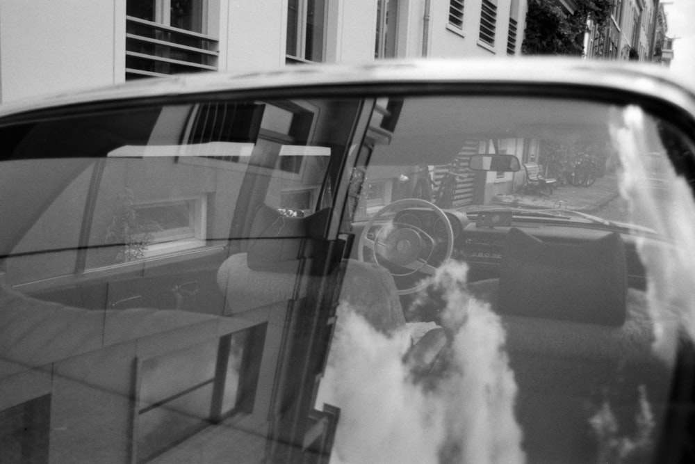 grayscale photo of car window with smoke