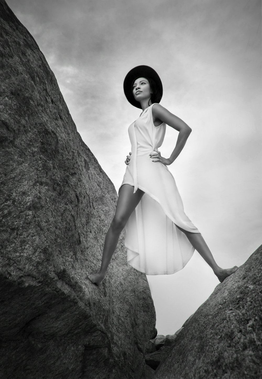 woman in white dress standing on rock