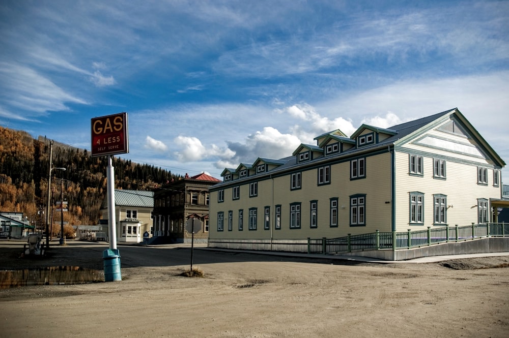 white concrete building near road under blue sky during daytime