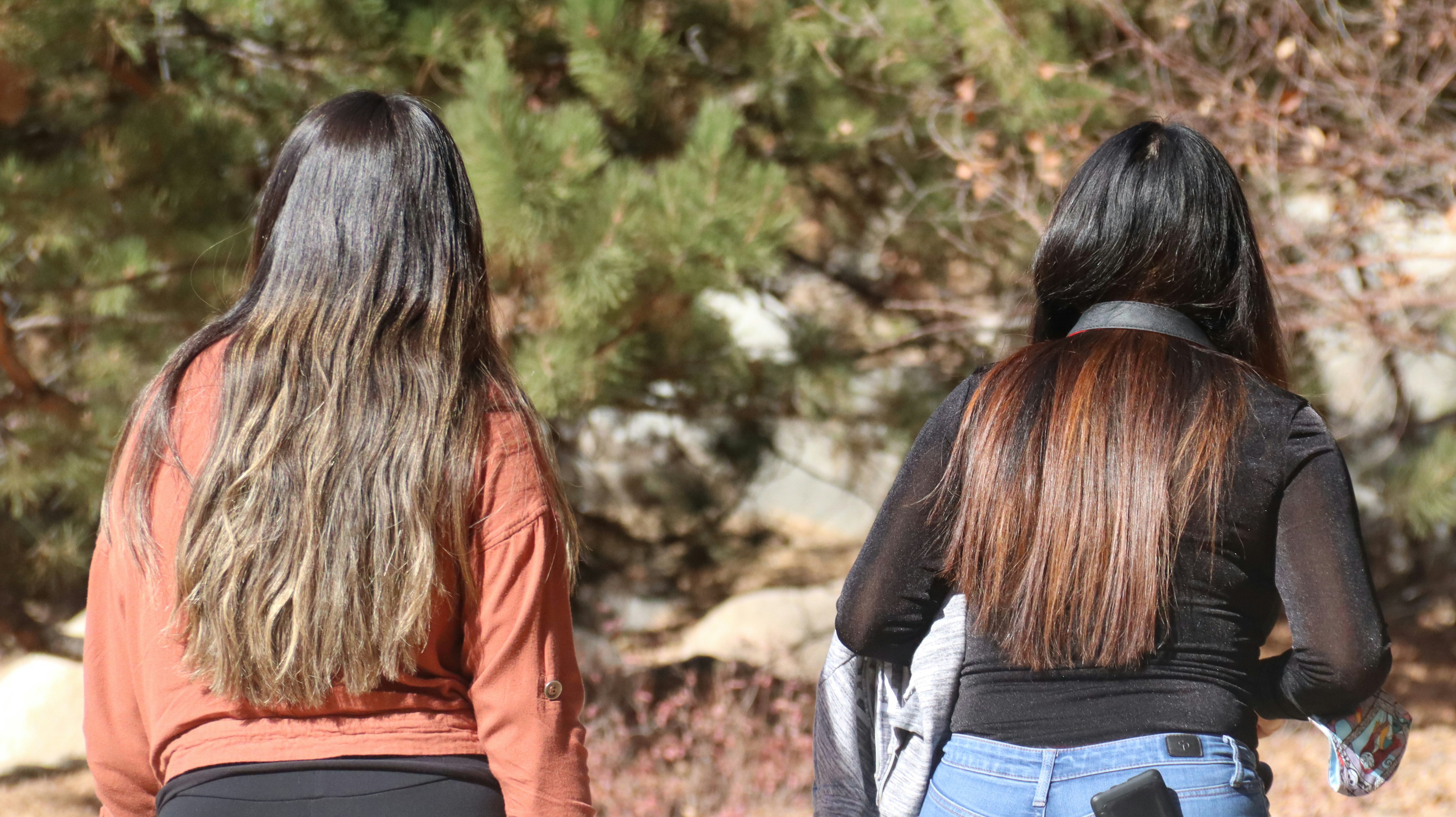 woman in brown jacket and blue denim jeans
