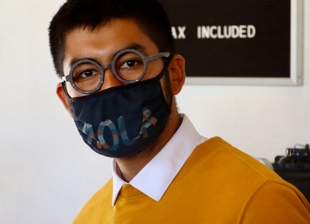 boy in yellow and white collared shirt wearing blue mask