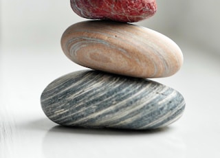 brown and gray stones on white surface