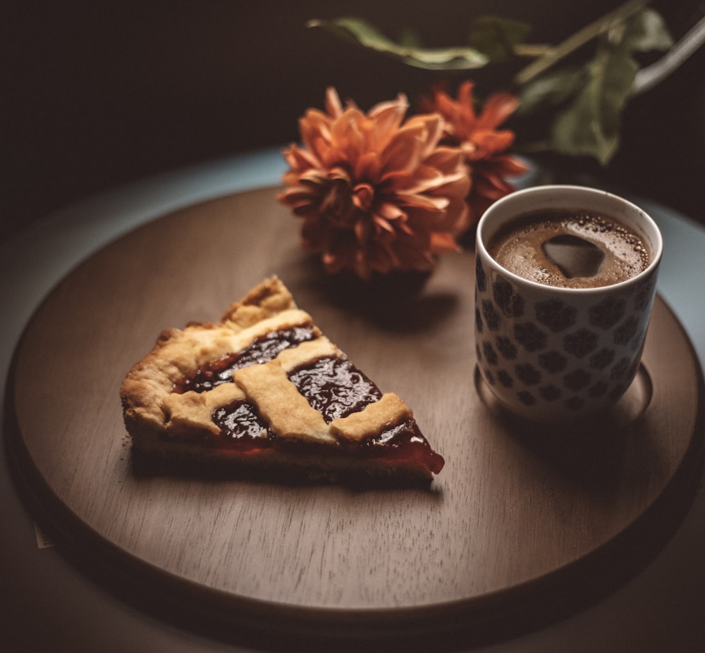 brown and white ceramic mug on brown wooden round plate