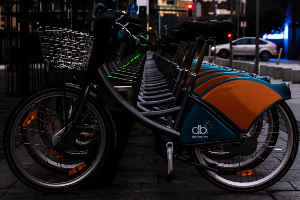 black and blue bicycle on black steel bicycle rack