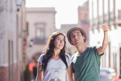 2 women smiling in the city during daytime