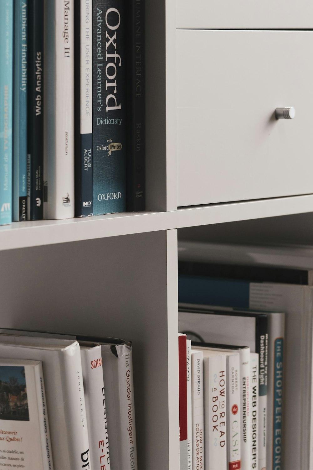 books on white wooden shelf