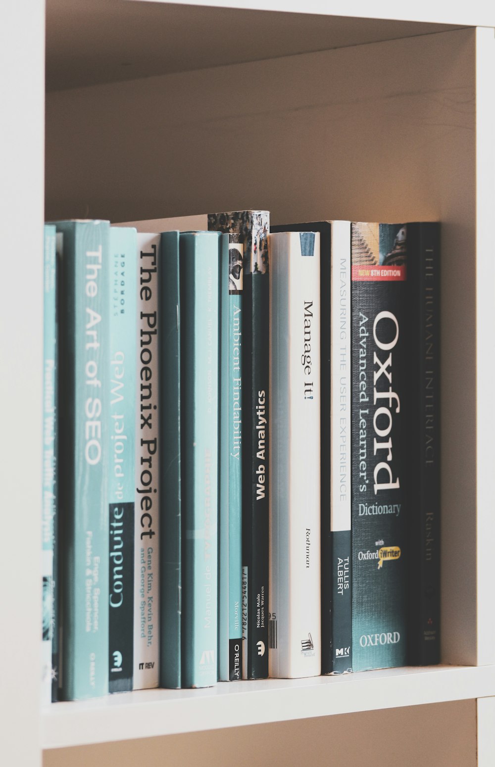 books on brown wooden shelf