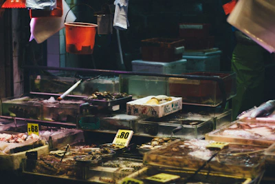 Close-up of fresh, glistening seafood on crushed ice at a market stall.