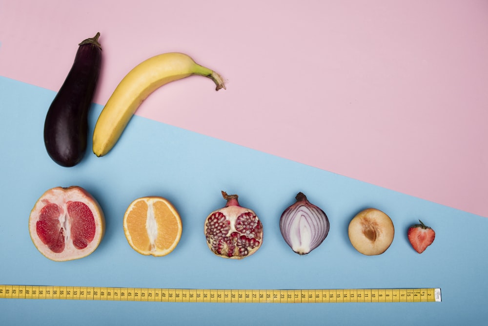 sliced orange fruits and yellow banana on white table