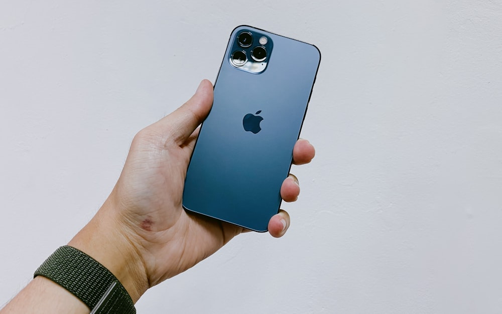 person holding blue iphone 5 c