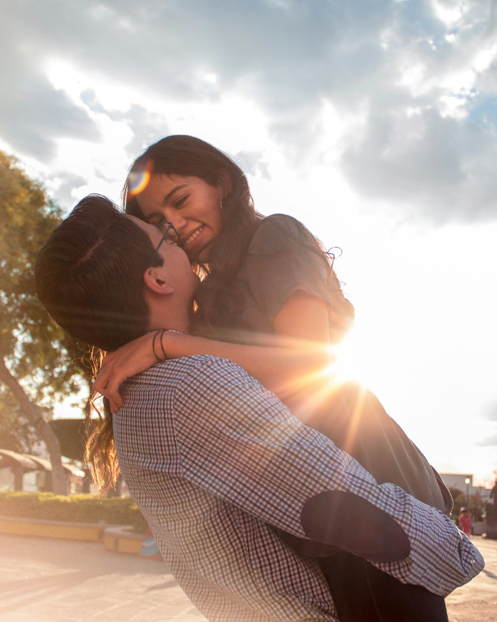 couple kissing under blue sky during daytime