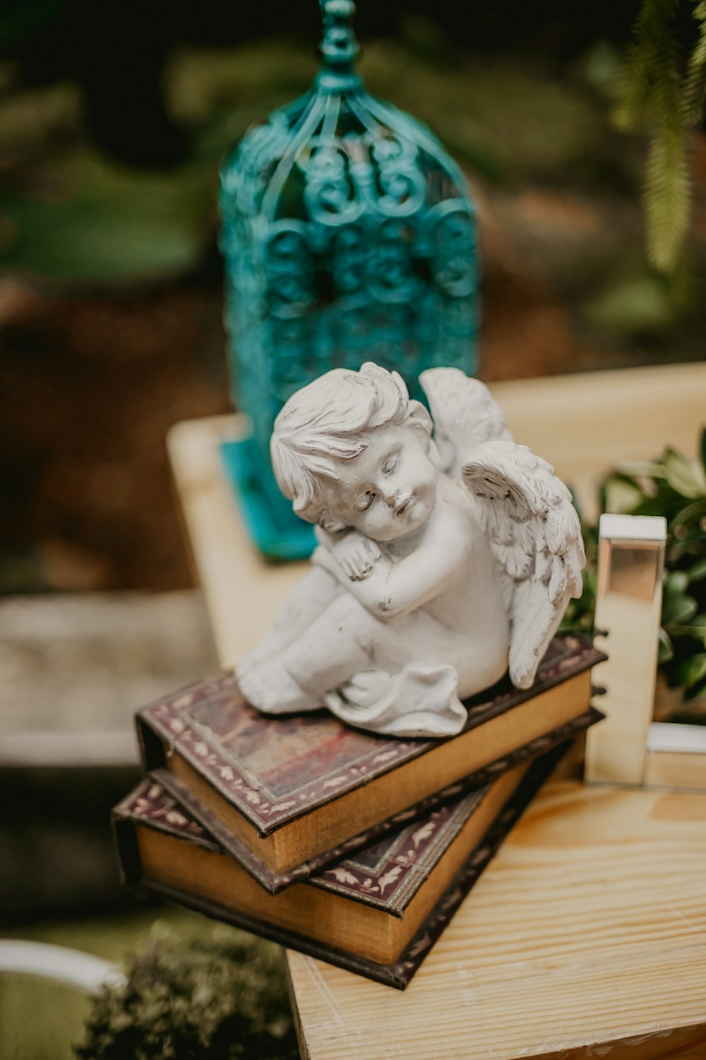 white ceramic angel figurine on brown book