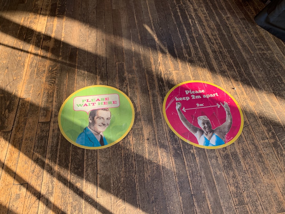 a couple of frisbees sitting on top of a wooden floor