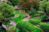 Lush residential garden with elegant stone pathways and vibrant flowering plants.