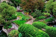Lush garden landscaping with stone pathways and decorative plants.