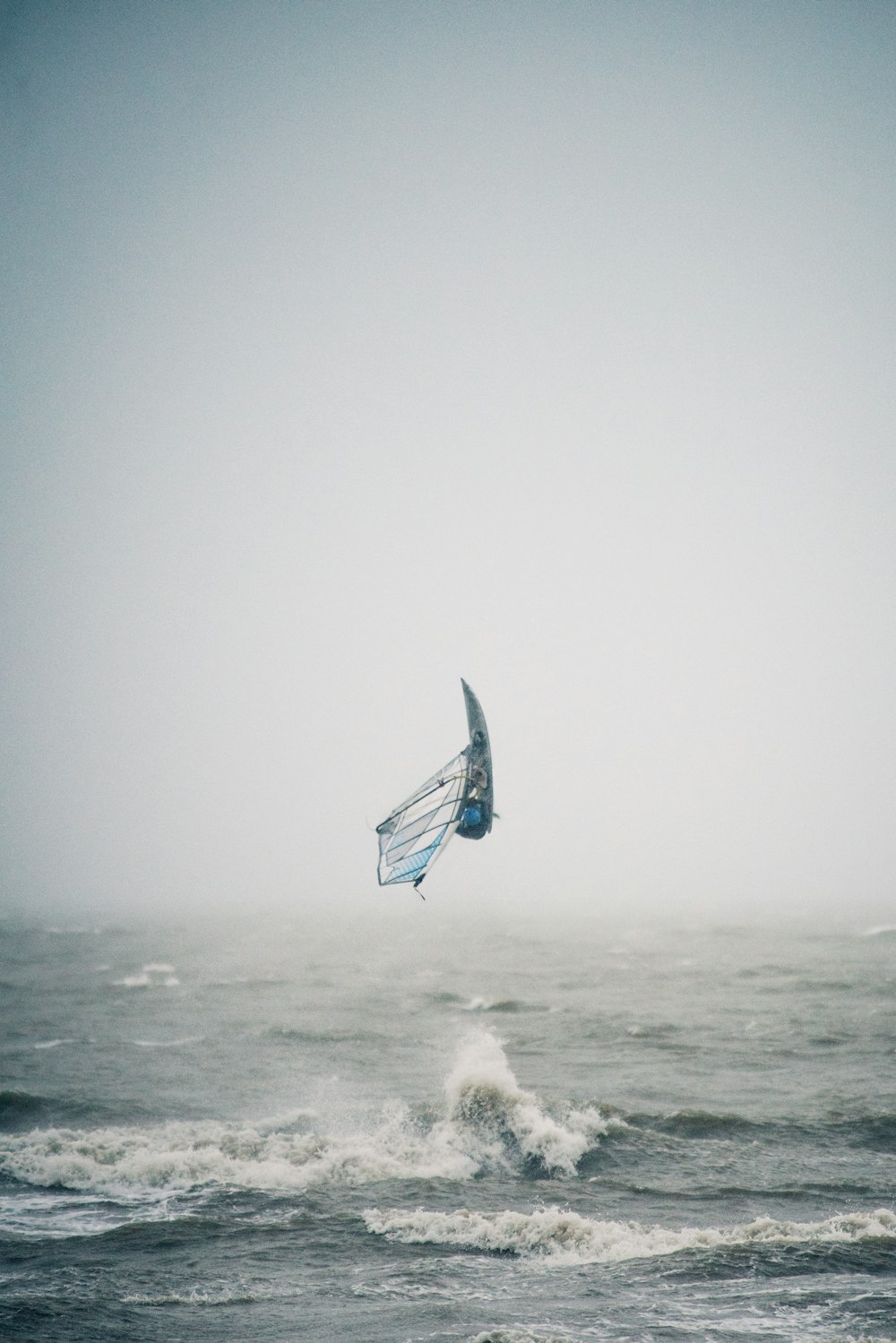 white and blue sailboat on sea during daytime