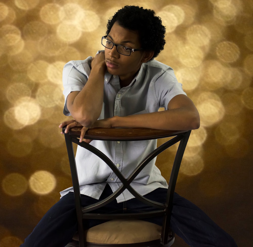 man in white button up shirt sitting on chair