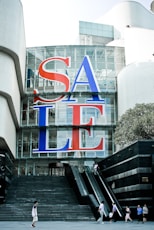 a large sale sign on the side of a building