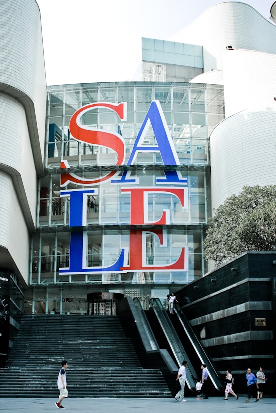 a large sale sign on the side of a building