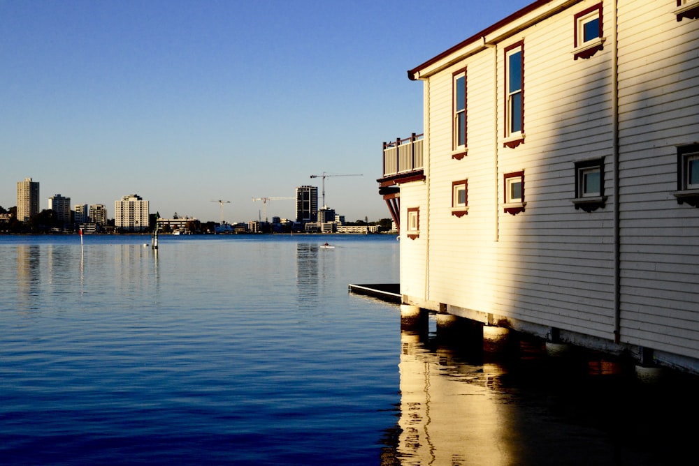 white and brown concrete building beside body of water during daytime