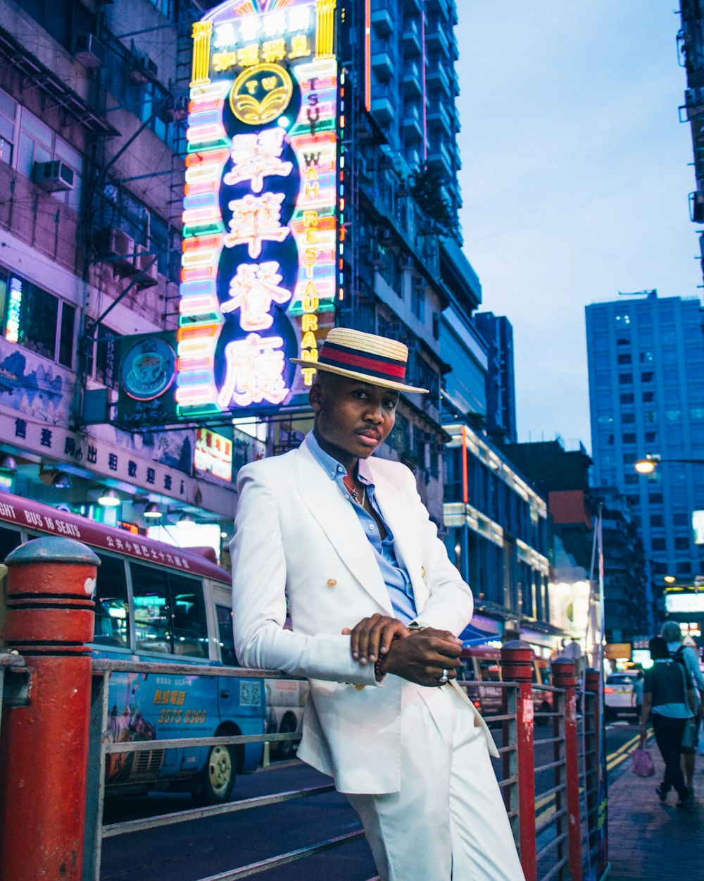 man in white coat standing on the street during daytime