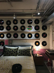 A modern bedroom wall decorated with a personalized song frame capturing a favorite track.