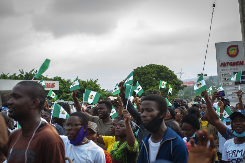 people gathering on green grass field during daytime