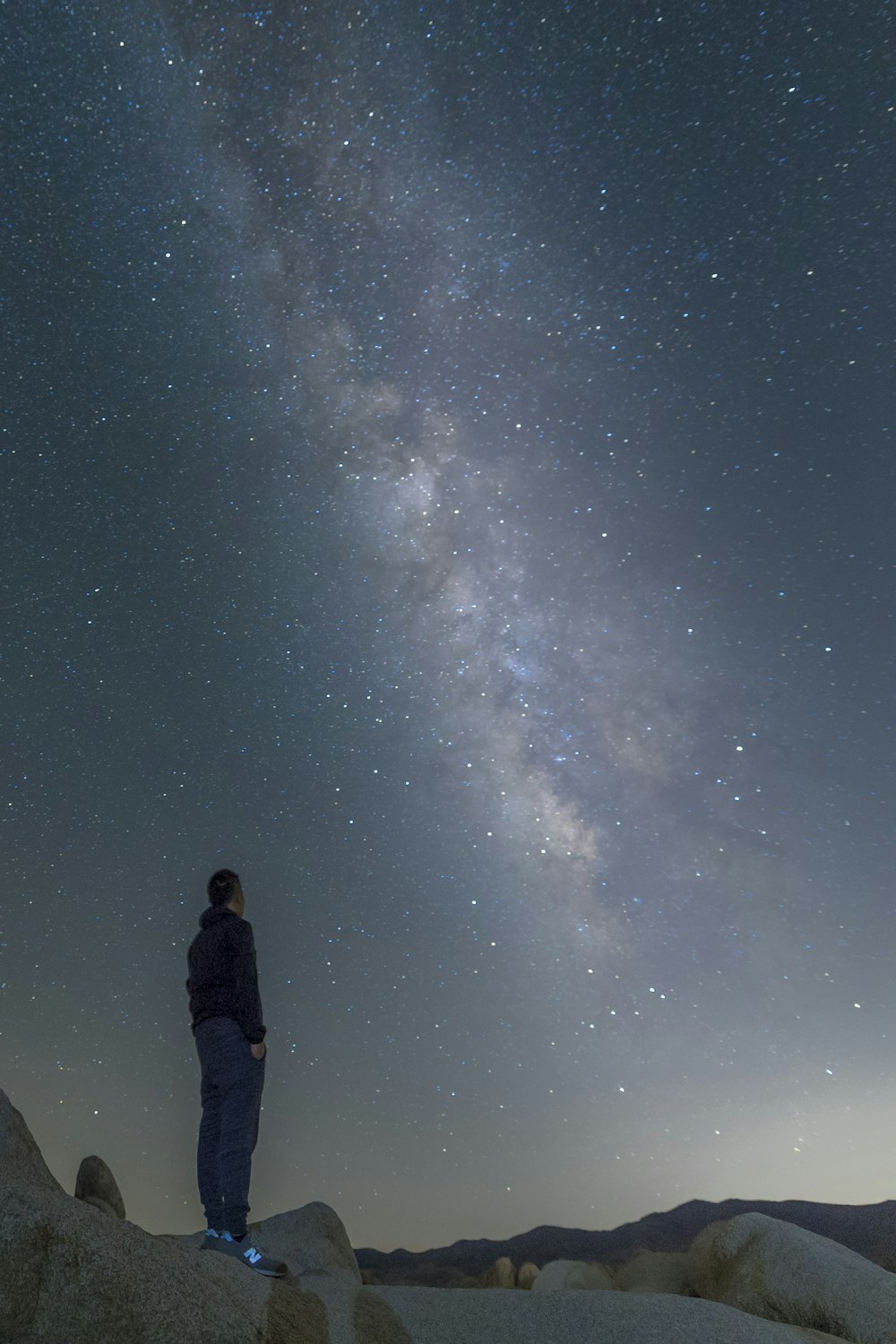 man in black jacket standing under starry night