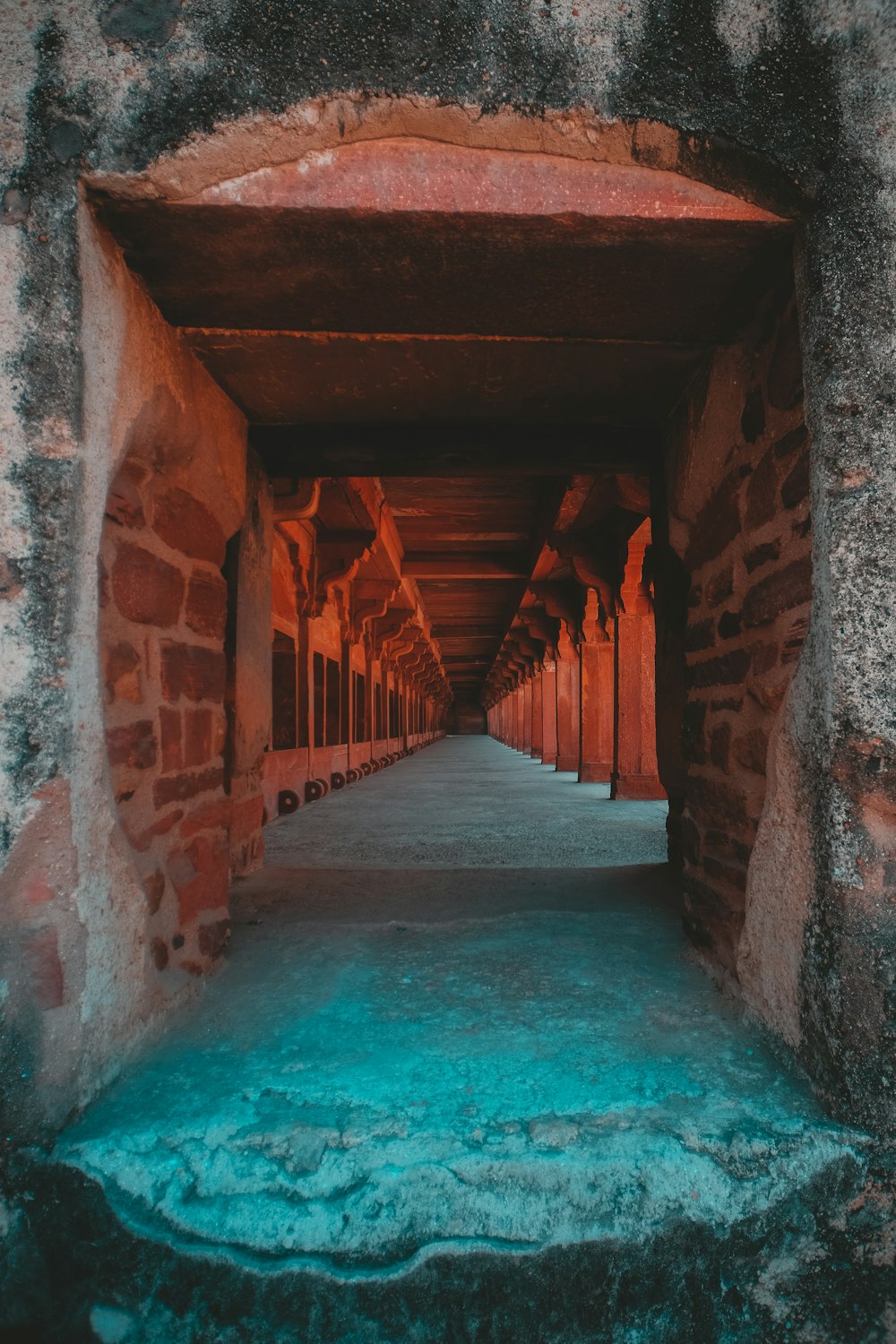 brown concrete hallway with blue water