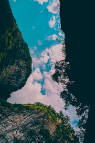 A serene view of a canyon with lush greenery and rocky cliffs.
