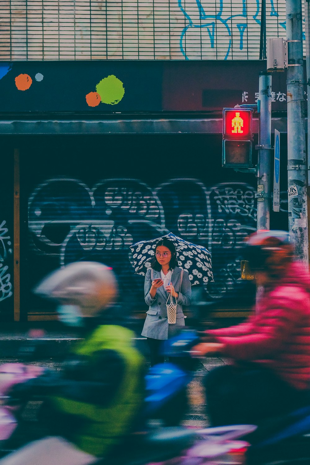 woman in white and black long sleeve shirt standing near black and white graffiti