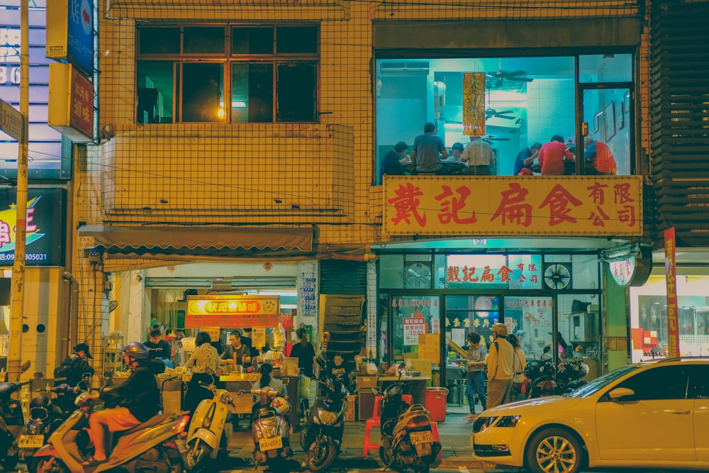 people sitting on bench in front of store during daytime