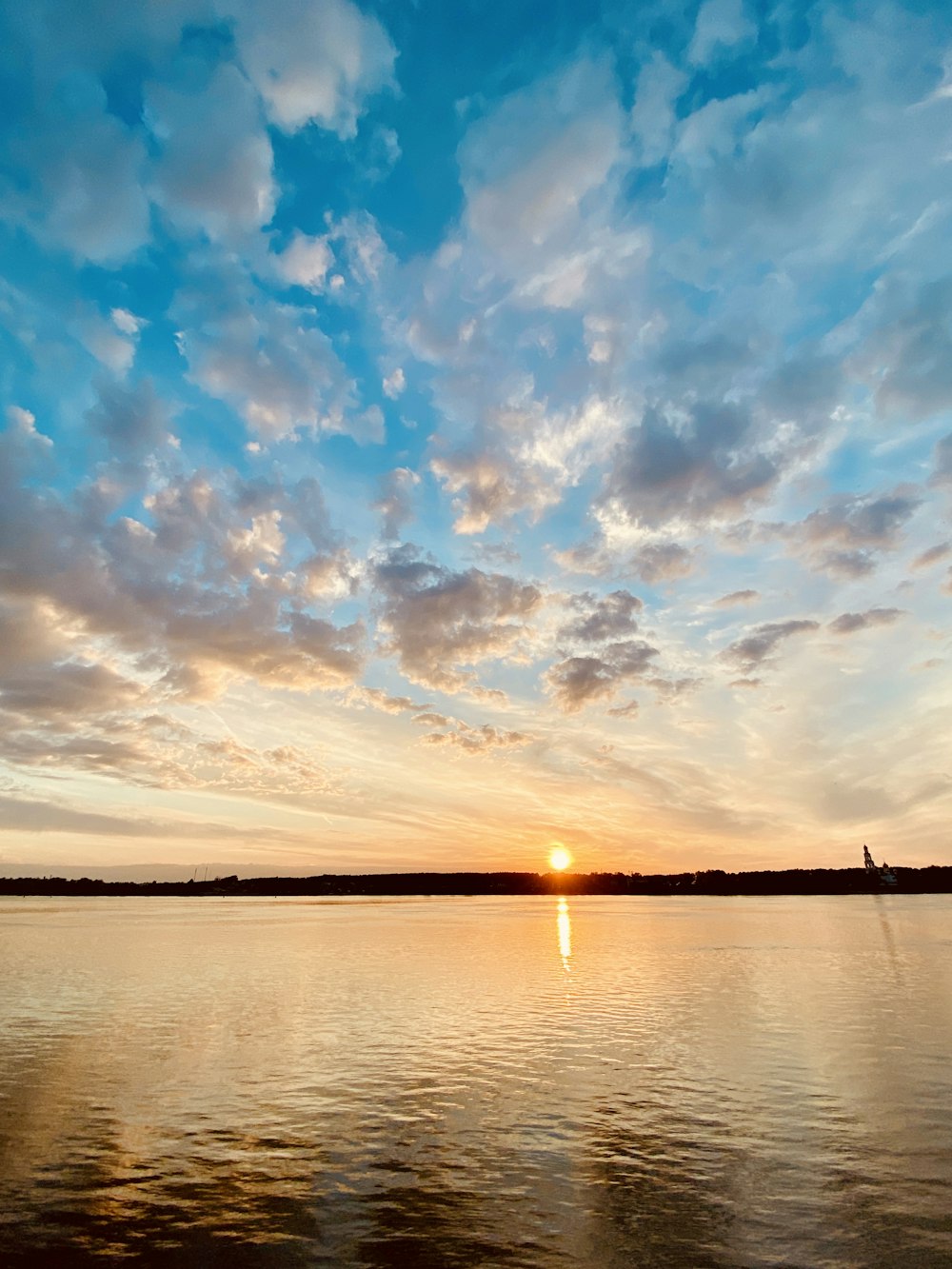 body of water under blue sky during sunset