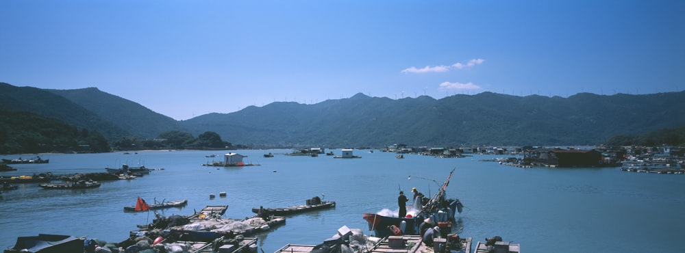 boats on sea near mountain during daytime