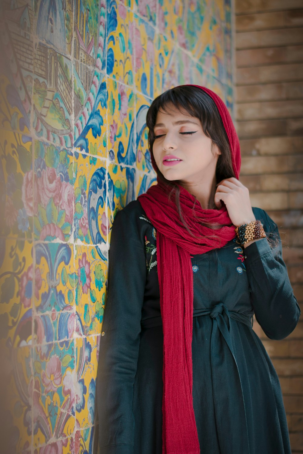 woman in black long sleeve shirt and red scarf