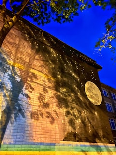 Local artists collaborating on a mural in an outdoor community space under soft evening light.