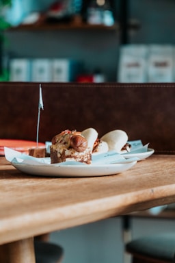 Image showing assorted tapas and pastries on rustic plates with natural light background.