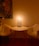 A cozy, dimly lit room with soft pillows and candles, perfect for a romantic retreat.