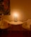 A warm, inviting consultation room with candles and love charms on a wooden table.