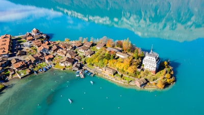 white and blue buildings near body of water under blue sky during daytime
