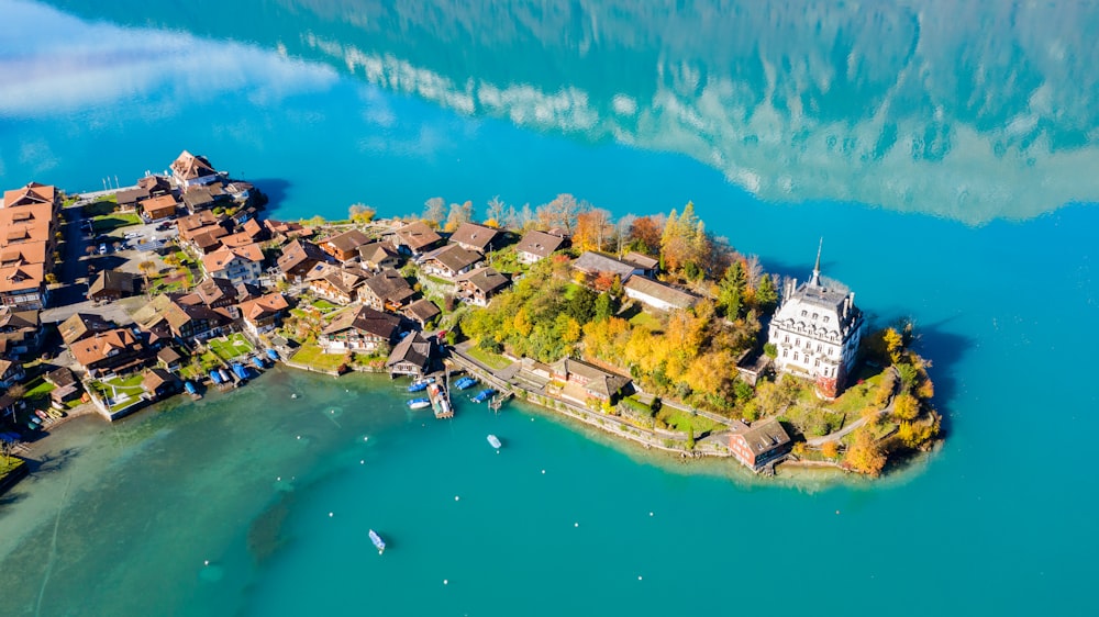 white and blue buildings near body of water under blue sky during daytime