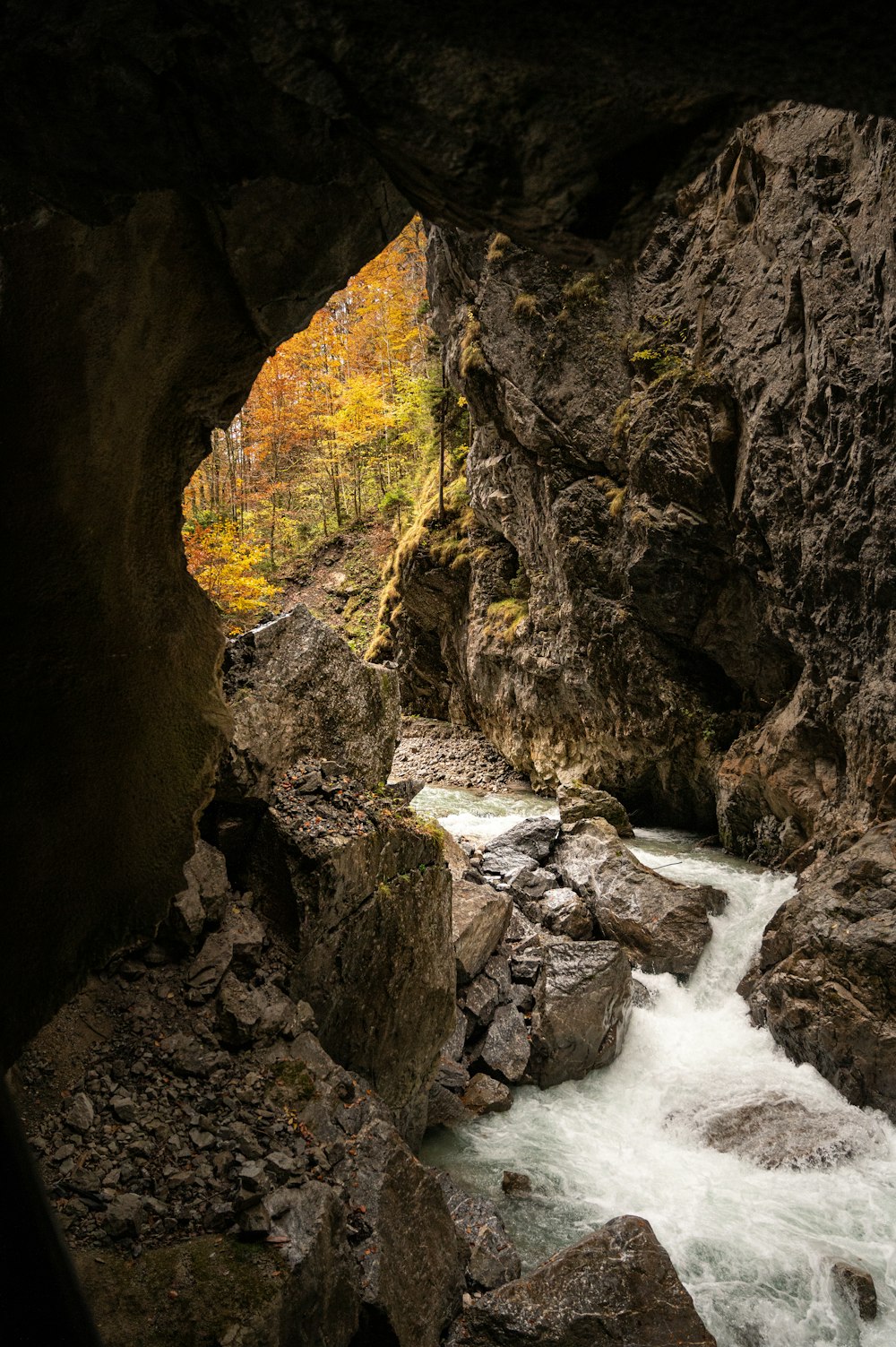 brown rocky mountain beside river during daytime