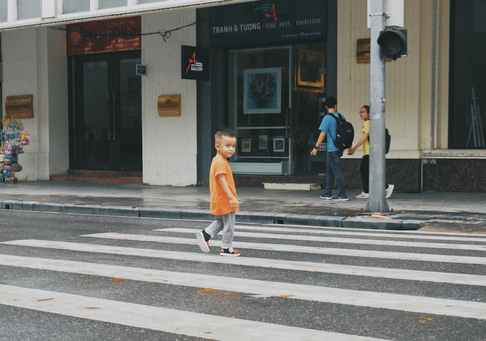 woman in white dress walking on pedestrian lane during daytime