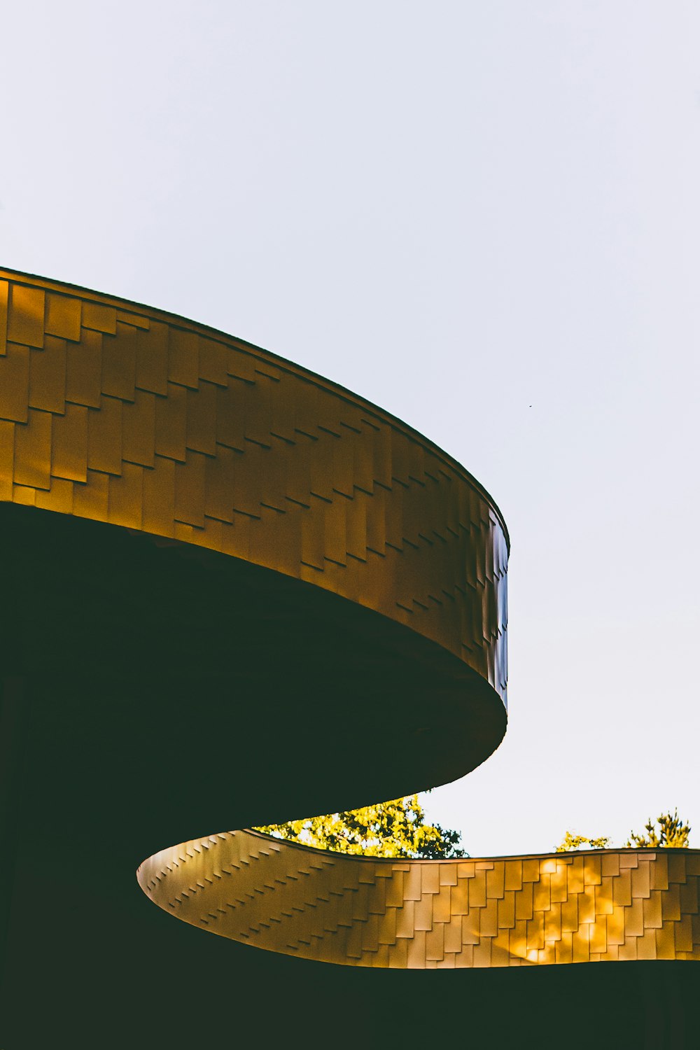 brown concrete building near green trees during daytime