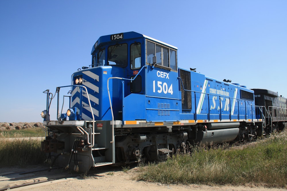 blue and brown train on rail tracks during daytime