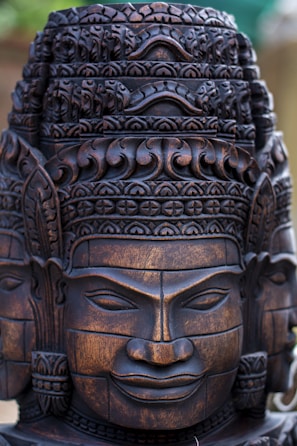 Close-up of a hand-carved wooden statue with intricate details.