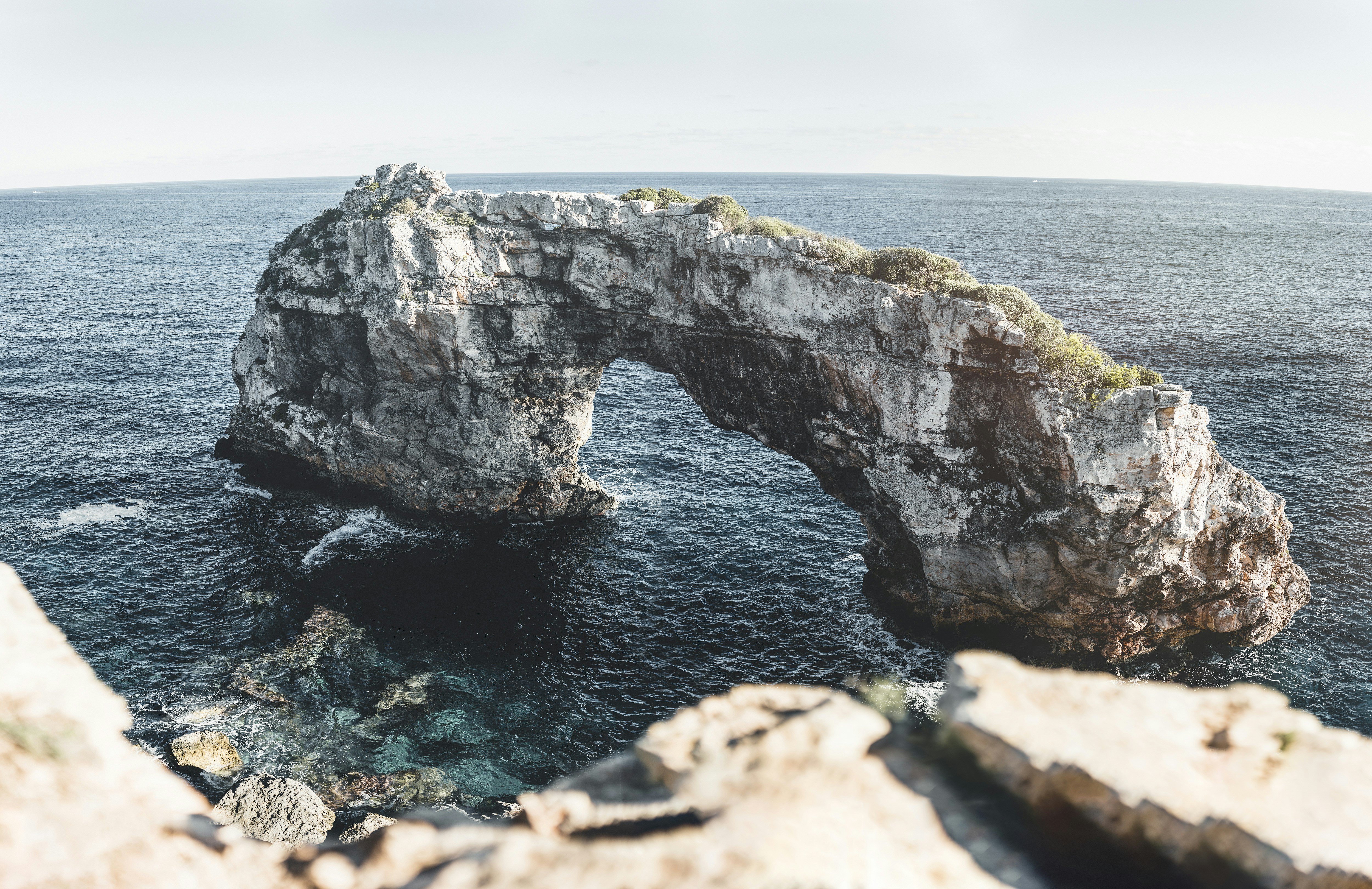 gray rock formation on sea during daytime