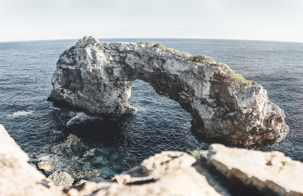 gray rock formation on sea during daytime